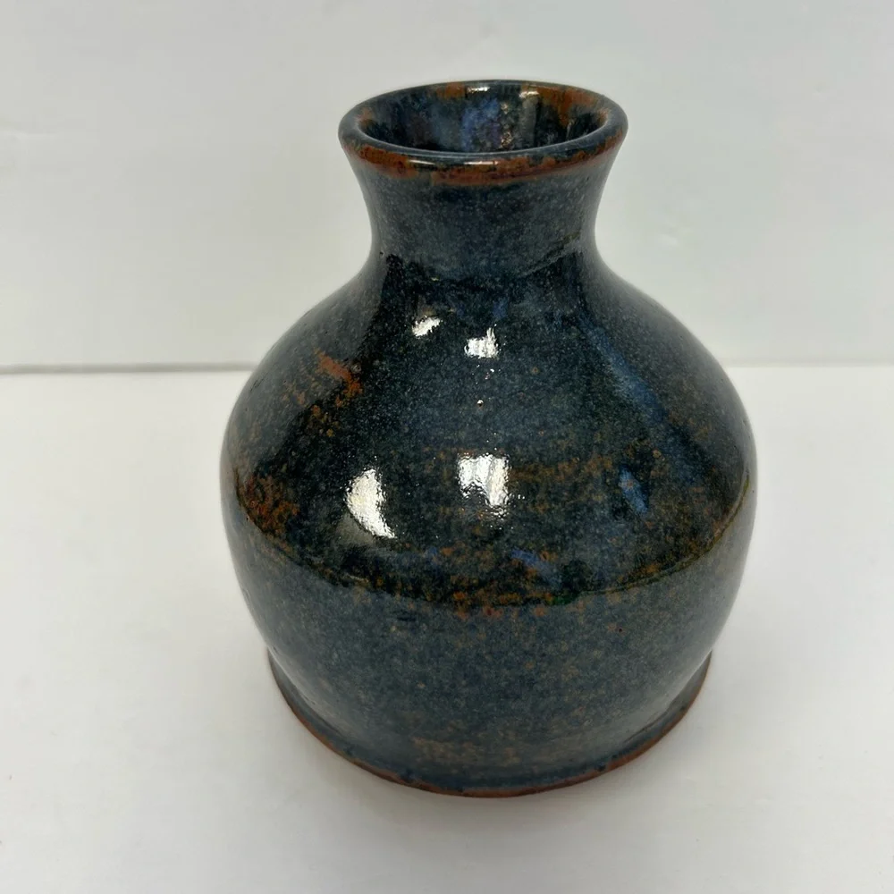 Handmade art pottery vase with a glossy glaze blend of blue and brown/ signed